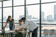 Group of professional business team brainstorming marketing idea.Young beautiful manager looking at laptop while listening coworker sharing idea at meeting. Working together. Skyscraper view. Tracery.