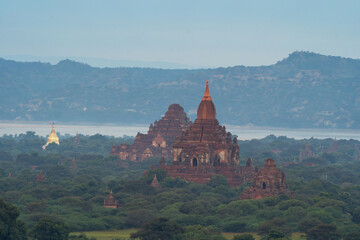 Aerial top view of burmese temples of Bagan City from a balloon, unesco world heritage with forest trees, Myanmar or Burma. Tourist destination.