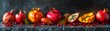 Panoramic view of vibrant tropical fruits, featuring ripe pomegranates and passion fruit, artistically displayed on a dark textured backdrop.