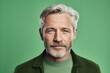 © Stocknterias - Handsome senior man with grey beard and mustache on green background