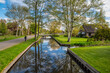 © Noppasinw - Giethoorn Netherlands, city skyline at canal and traditional house in Giethoorn village