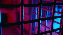 Cinematic Metal Bars In Scary Dungeon Cell For Torture. Abandoned Prison. Creepy Cage Underground. Thriller Jail Lit With Ambient Red And Blue Neon Light. Ancient Underground Chamber. Old Prison Grate