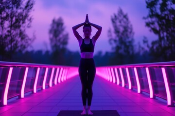 Sticker - yoga practitioner on a bridge at dusk with purple and pink illuminated background