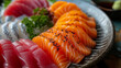 Japanese sashimi slices of fresh raw salmon and tuna on a plate inside a sushi restaurant.