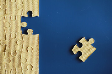 Wall Mural - Clean puzzle elements on the background. Empty puzzle piece on the table. Teamwork concept.