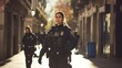 A Spanish security force policewoman and many bodies are seen strolling down a downtown street.