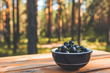 Wall Mural - Simple and inviting image of bowl filled with fresh grapes sitting on rustic wooden table. Perfect for showing healthy eating, natural food, or farm-to-table concept
