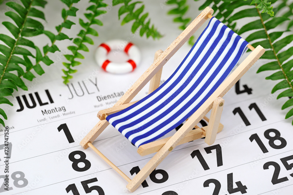 German monthly calendar shows the month of July with deck chair and ...