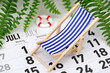 German monthly calendar shows the month of July with deck chair and tropical plants on background, concept of planning summer vacation