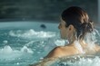 woman in a hydrotherapy pool, water jets directed at her shoulders