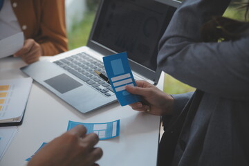 Close up ux developer and ui designer use augmented reality brainstorming about mobile app interface wireframe design on desk at modern office.Creative digital development agency