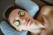 woman with cucumber slices on eyes, reclining on a massage table