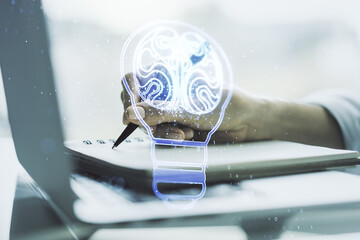Poster - Creative light bulb illustration with human brain and hand writing in diary on background with laptop, future technology concept. Multiexposure