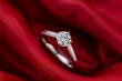 diamond ring on red silk with soft folds