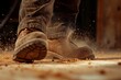 closeup on a lumberjacks boots stepping on sawdust