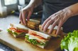 worker preparing sandwiches on cutting board for quick lunch