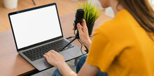 Woman Hand Type On The Keyboard On Laptop With Mockup Of Blank Screen And Microphones For Record Podcast Interview For Radio.