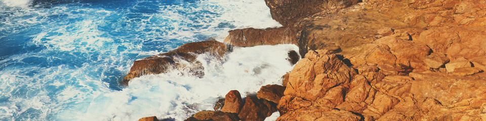 Wall Mural - Rocky seashore. Stormy sea. Beautiful wild nature. Horizontal banner