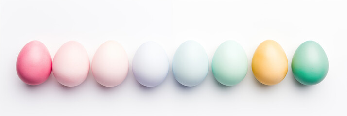 Wall Mural - Various Easter eggs aligned on white background banner. Panoramic web header. Wide screen wallpaper