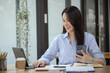 © SOMKID - Happy asian young businesswoman excited with smartphone at workplace, Excited happy Asian woman.