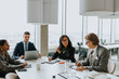 © Maskot - Multiracial business colleagues discussing strategy in board room