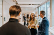 © Maskot - Business delegates with drink discussing strategy during networking event