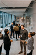 © Maskot - Multiracial professionals discussing during networking conference