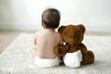 AI Generated Illustration Of A Baby Boy With Teddy Bear Sitting On The Floor Wearing Diapers