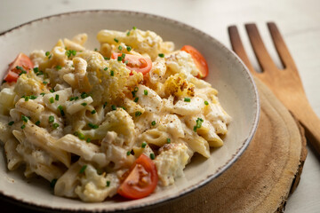 Wall Mural - Macaroni cooked with cream, cheese and baked cauliflower.