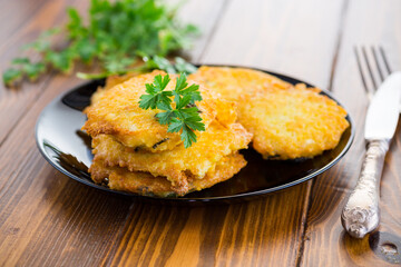 Wall Mural - fried vegetarian potato pancakes in a plate.