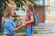 © Dragana Gordic - First day at school. mother leads a little child school girl in first grade. Mother Saying Goodbye To Children As They Leave For School