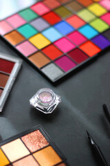 Canvas Print - Various colorful make up products on dark background. Selective focus.