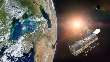 Wall Mural - space telescope, above the earth planet, with the sun light. elements of this image furnished by nas