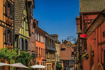 Poster - Traditional colorful half timbered houses in a popular village on the Alsatian Wine Route in Riquewihr, France