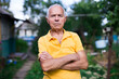 © caftor - Portrait of an elderly man 70 years old in his garden on summer sunny day