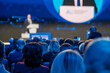 © Anton Gvozdikov - Focused audience listening intently to a speaker at a professional business conference.