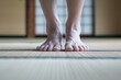 closeup of feet stepping onto a tatami mat, ready for training