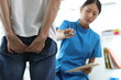 © Wasan - Doctor is diagnosing butt pain and hemorrhoids treatment of male patient in exam room at hospital.