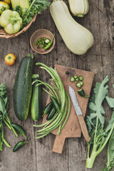 Wall Mural - Farm vegetables , zucchini, white bell pepper, string beans, broccoli on a wooden background. Vegan food. Top view.