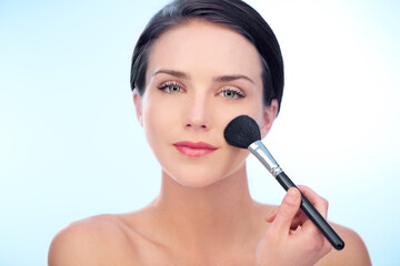 Woman, portrait and makeup brushes in studio with cosmetic, beauty tools or product application for skincare. Model, face and confidence with skin wellness, cosmetology or grooming on blue background