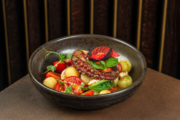 Wall Mural - Grilled octopus tentacle with potatoes and tomatoes