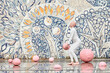 Young hairless girl ballerina with alopecia in white futuristic suit dancing outdoor and jumps with pink sphere on abstract mosaic Soviet background, symbolizes self expression