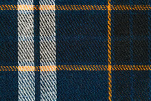 Close-up Of Blue, White And Orange Checked Tartan Fabric Texture. Image For Your Design. Material For Making Shirts