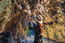 Asian Women Tourist Lifts Camera To Take A Photo Inside Tham Lod Cave Pai, Maehongson, Tham Lod Cave One Of The Most Amazing Cave In Thailand.