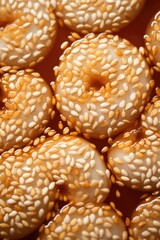 Poster - A close-up view of a plate filled with delicious donuts topped with sesame seeds. Perfect for food lovers and bakery enthusiasts