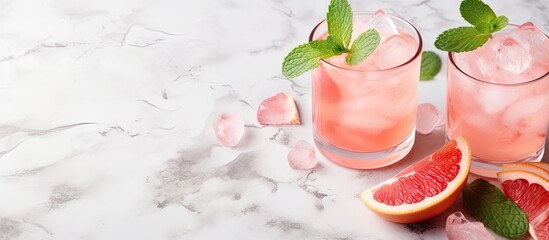 Aufkleber - Preparation of a grapefruit alcohol free cocktail several tumbler glasses with ice cubes on marble surface with fresh mint. Creative Banner. Copyspace image