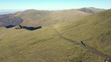 Aerial View Of People Hiking And Climbing Snowdon Mount In Wales On A Sunny Day