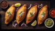 Delicious Empanadas - South American empanadas served with lime and fresh salsa on a rustic wooden board.
