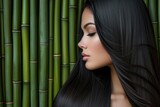 Portrait of a woman with straight hair and bamboo background