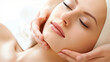A beautiful woman receiving a facial massage treatment. Skin care.  White background. 